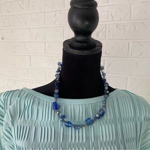 Blue glass beaded necklace on silver strand.